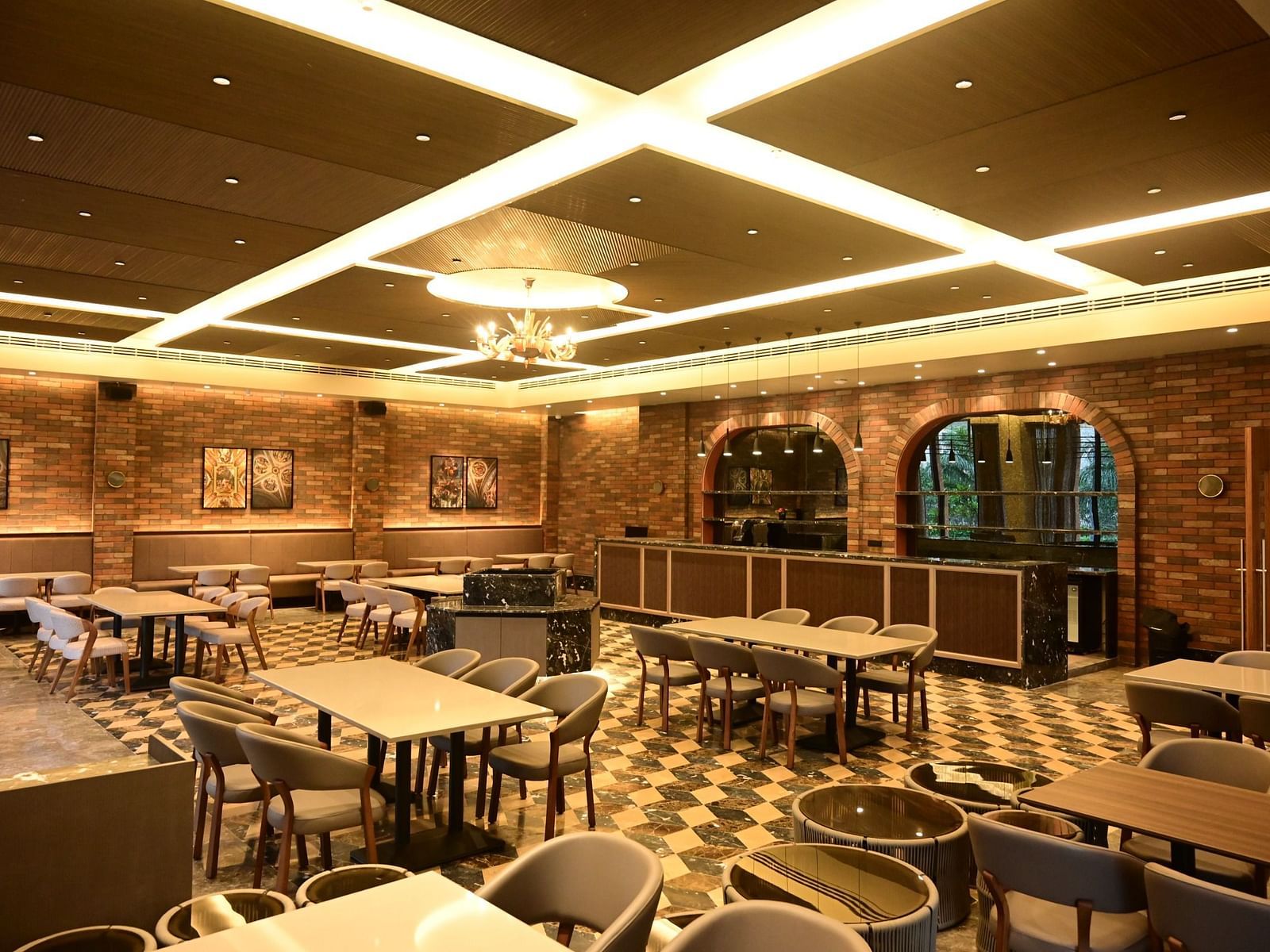 image of the dining area at the restaurant at club charholi, pune with well arranged seating area